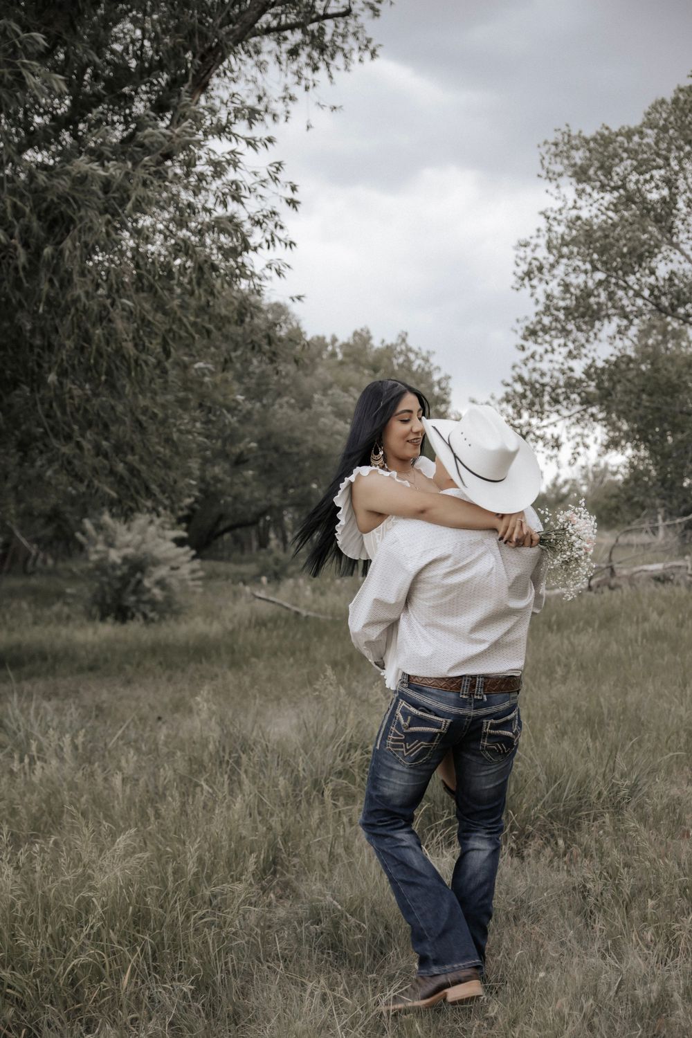 Man carries his partner under trees