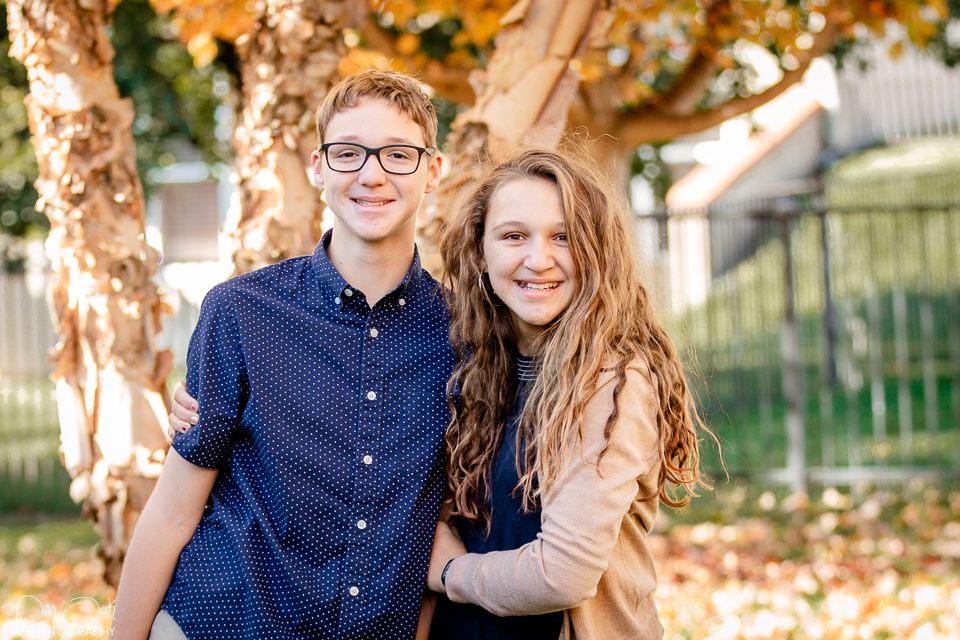 Siblings hugging and being silling for family portraits