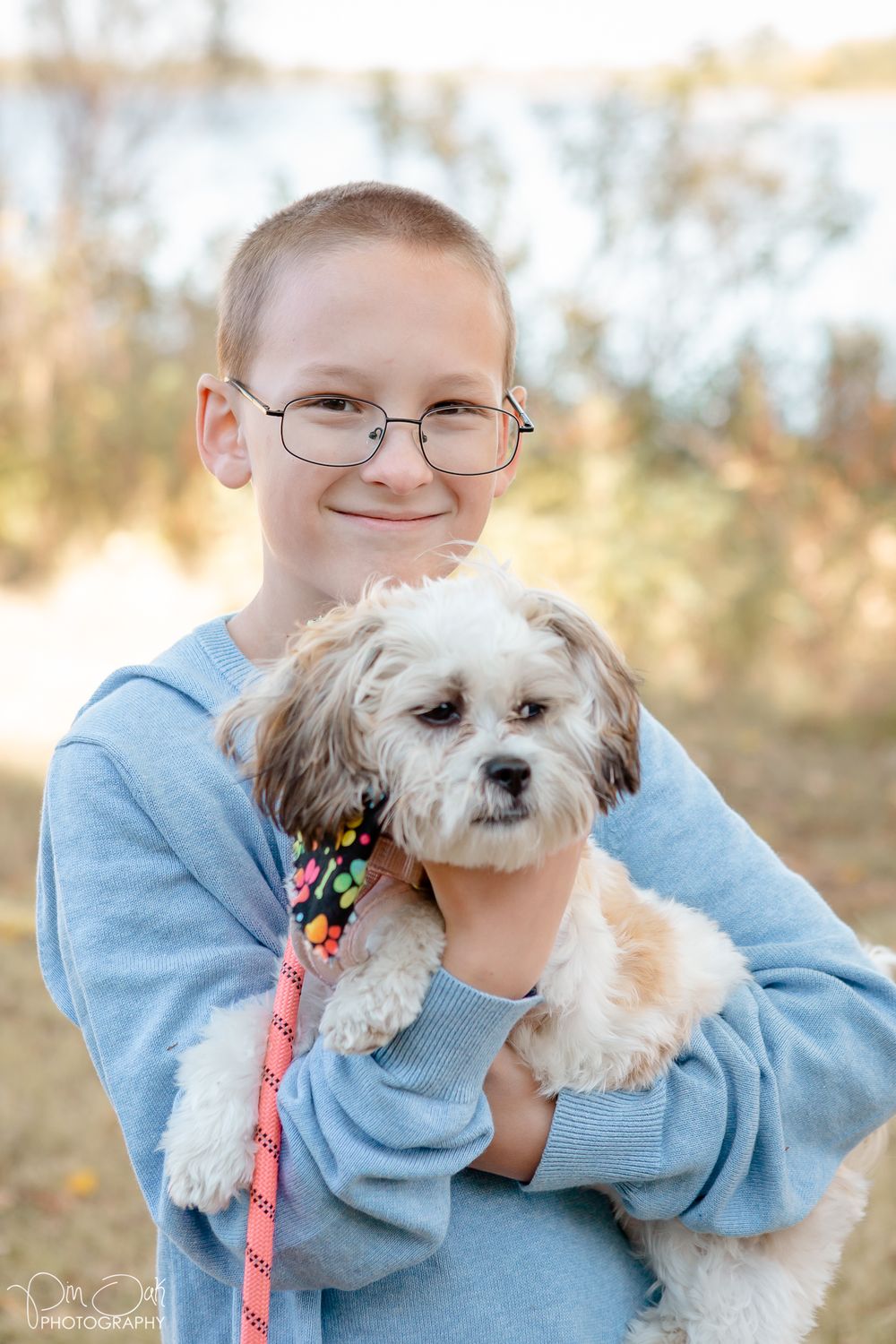 Portrait of a boy holding his dog