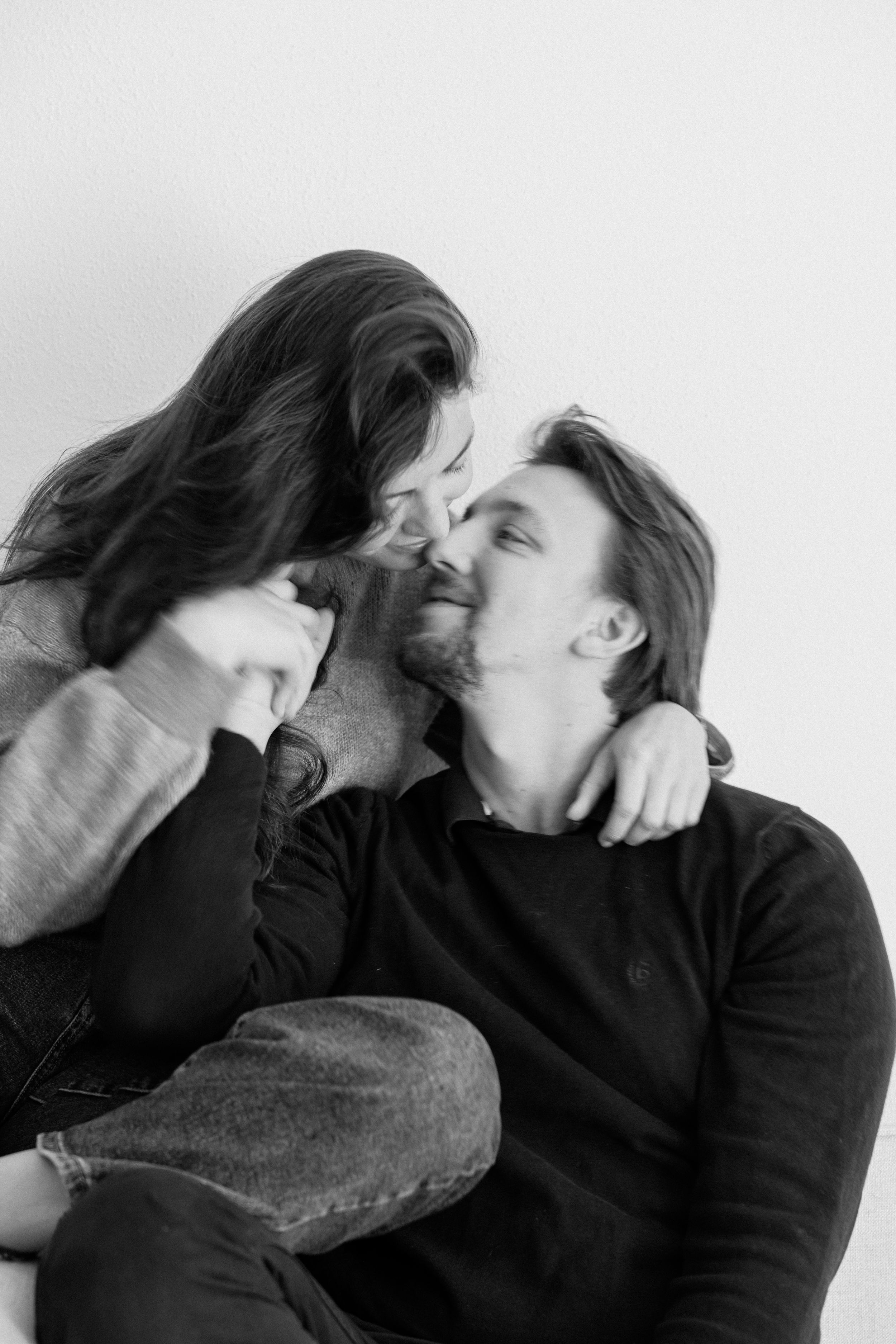 Intimate black and white portrait of couple sharing tender moments.