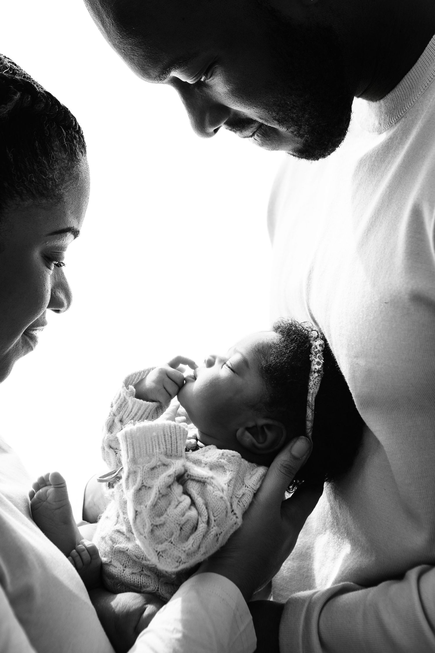 Black and white series of intimate family moments with newborn baby.
