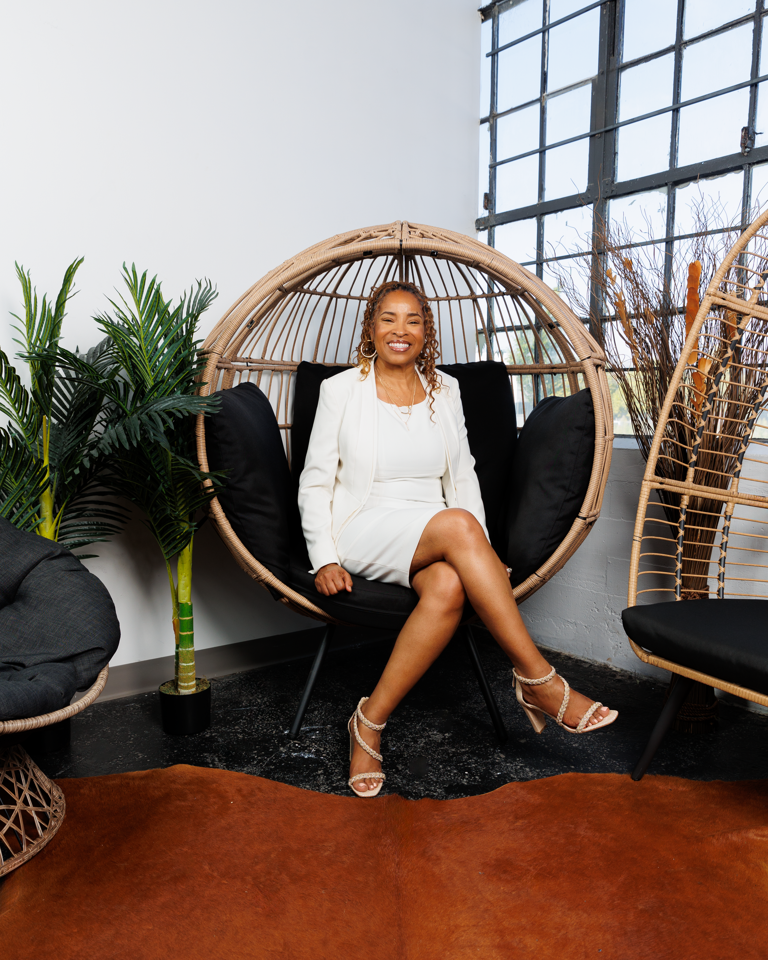 A series of five connected images showing someone sitting on a black couch in various relaxed poses.