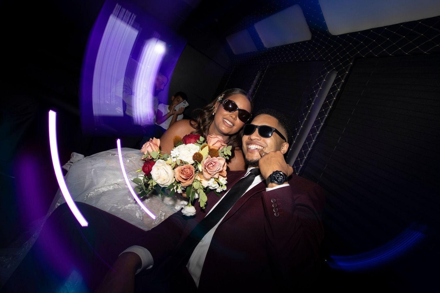Silhouetted figures dance and celebrate in a dark nightclub setting with purple lighting effects.
