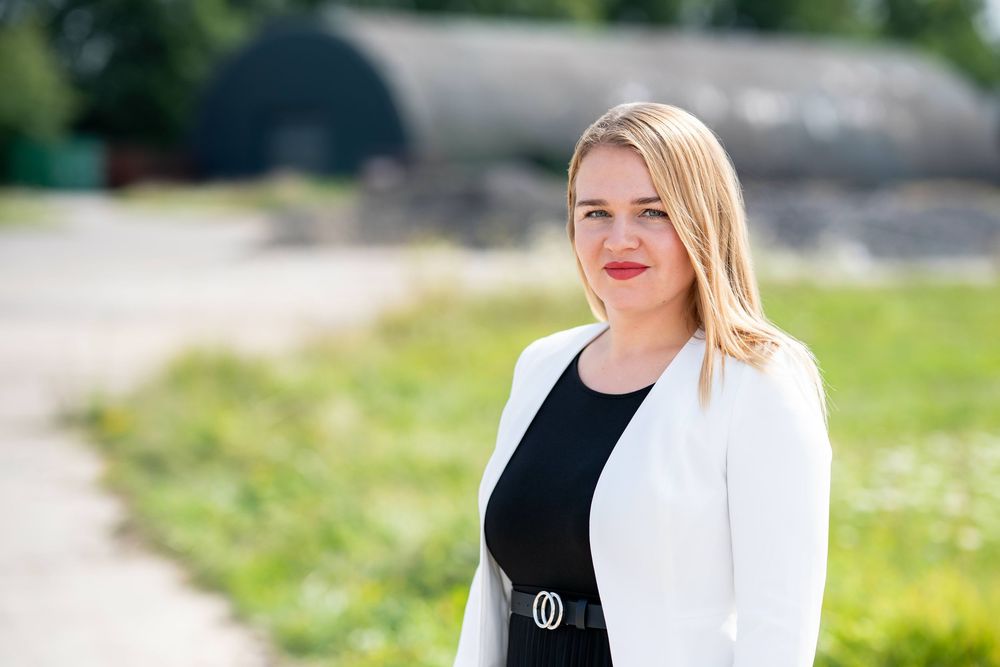 Professional headshot portraits of people in business attire against outdoor backgrounds with natural lighting.