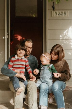 Casual family portrait on porch.