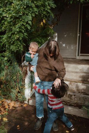 Playful sequence of people sitting on concrete steps surrounded by green foliage in a candid outdoor setting.