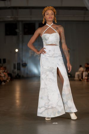 White halter dress with side slit and textured fabric showcased at Columbia Fashion Week.