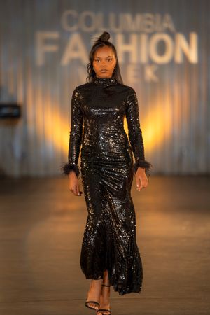 Long-sleeved black sequin gown with mock neck and mermaid silhouette displayed at Columbia Fashion Week.