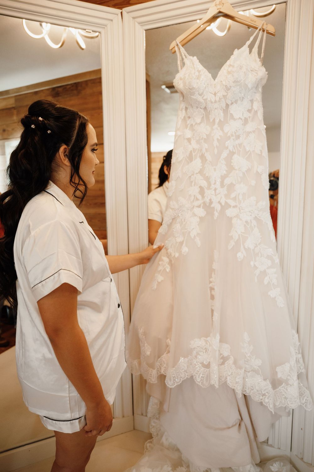 A series of photos showing a white wedding dress being prepared and examined in a bridal fitting room.
