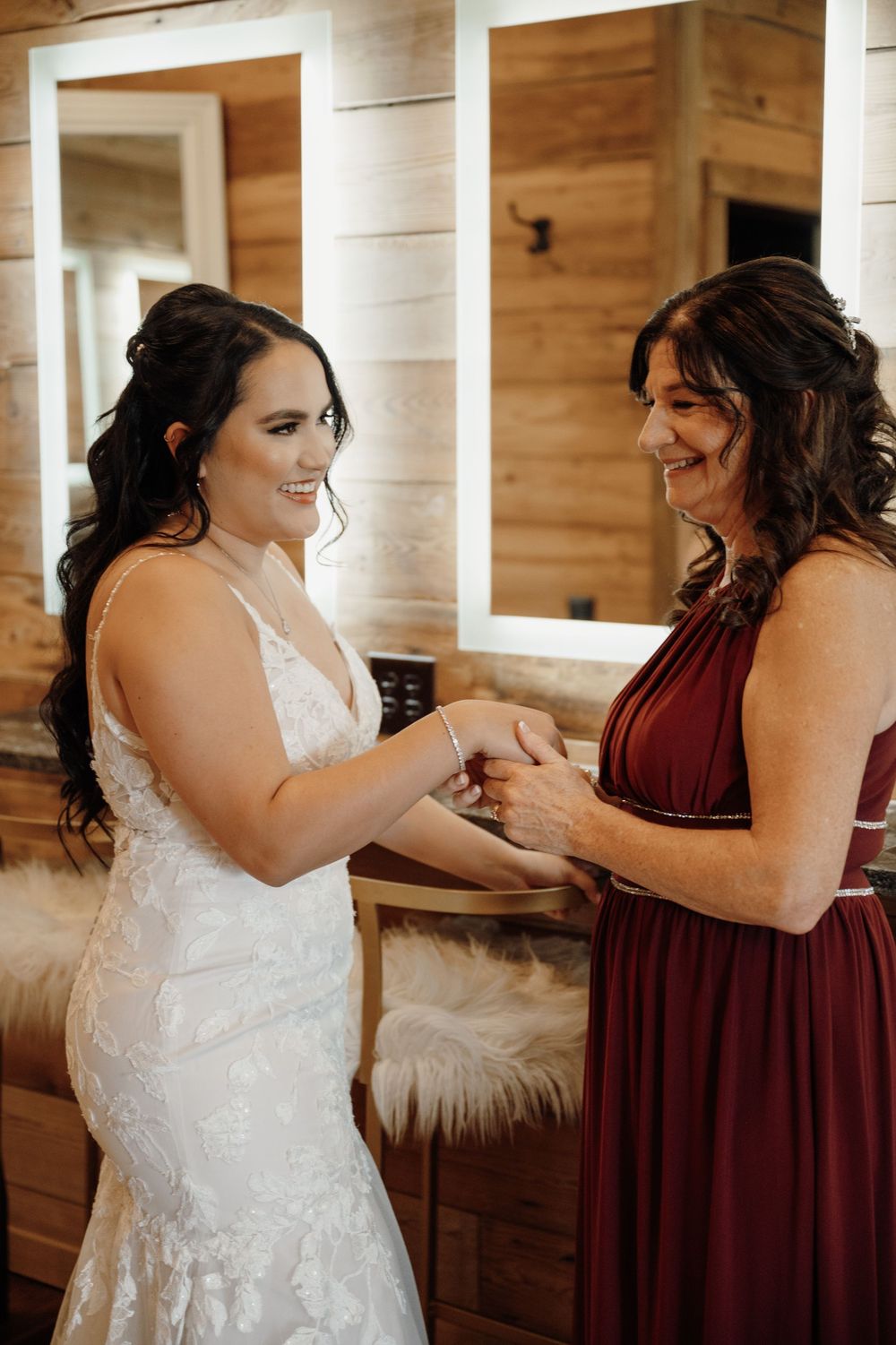 A series of getting ready moments showing a bride and bridesmaid in burgundy helping each other prepare for the wedding.