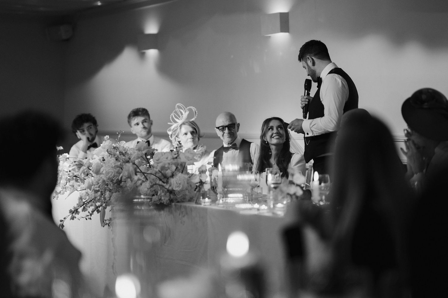 bride smiling at groom giving speech at Iscoyd park