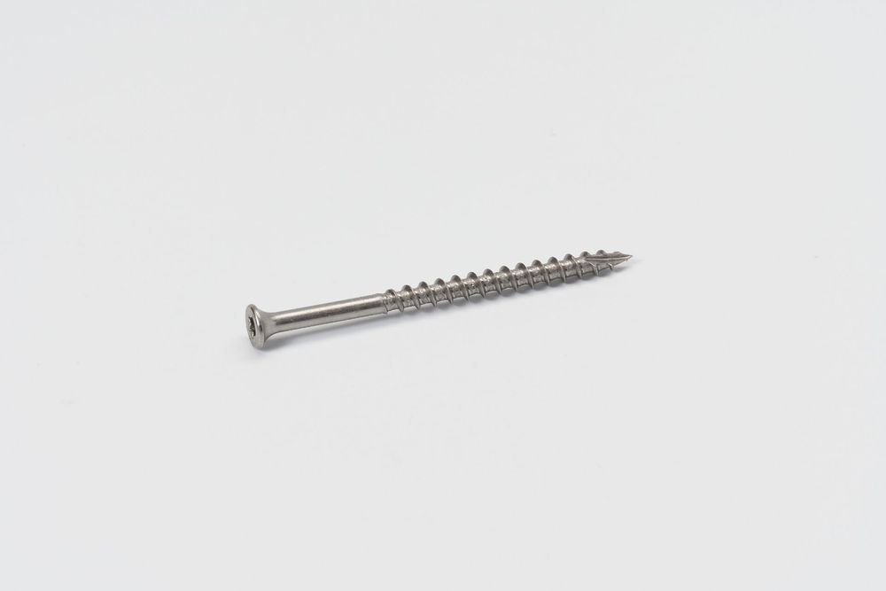 Long stainless steel wood screw with sharp point and flat head against white background.