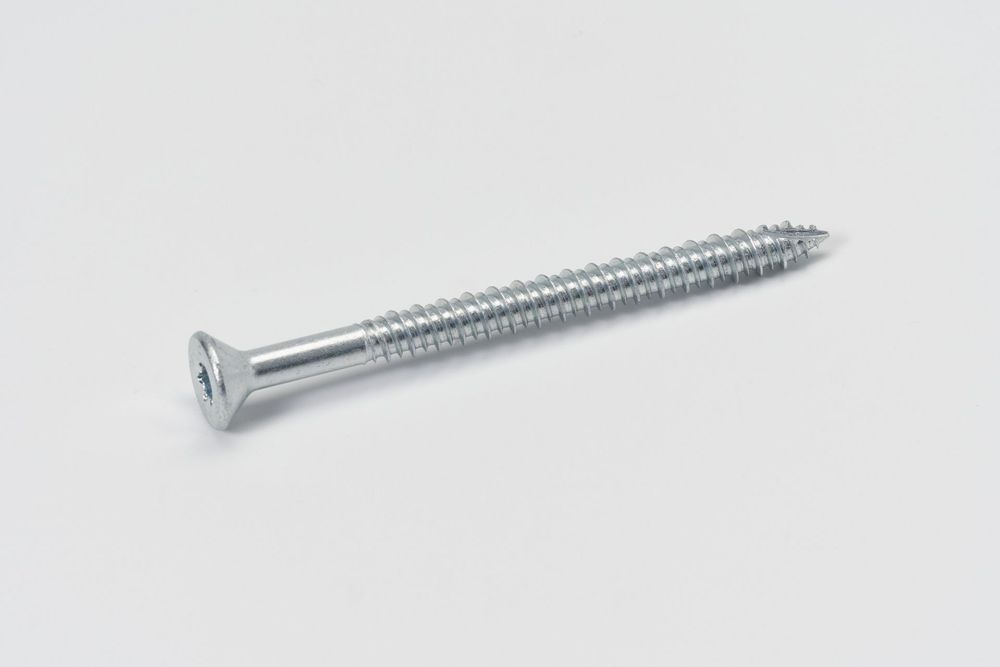 A series of four identical silver metal screws with flat heads and threaded shafts shown in decreasing sizes against white.