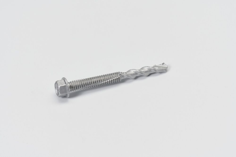 Close-up view of stainless steel screws with threaded shafts on white background.