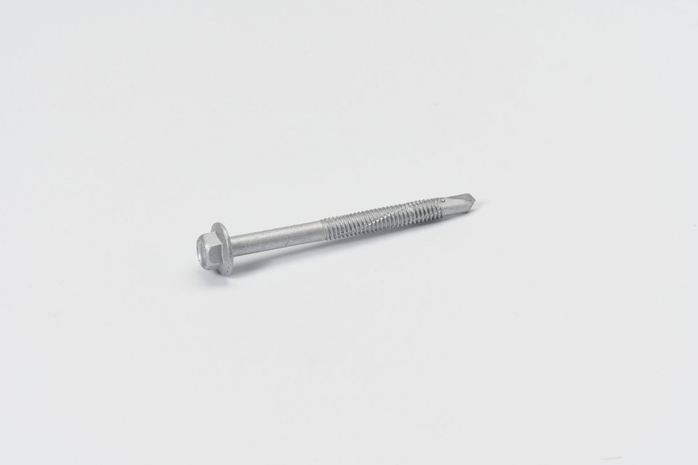 A long silver metal screw with a sharp point and threaded shaft isolated on a white background.