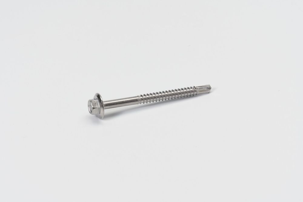 A long silver metal screw with a sharp point and threaded shaft isolated on a white background.