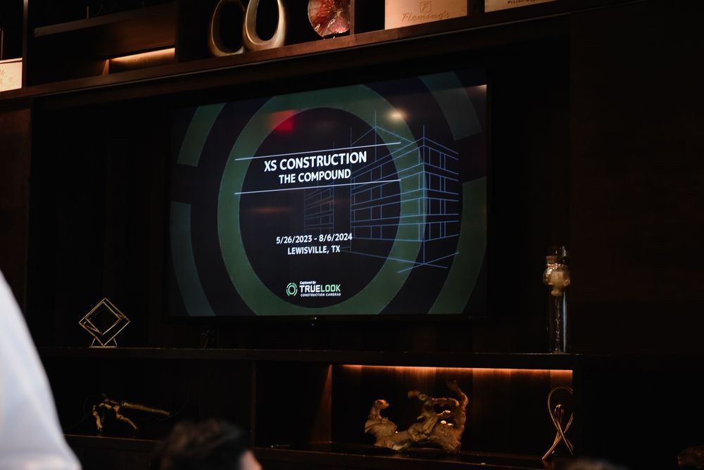 Dark computer screen displays showing a user interface with glowing green circular elements and text.