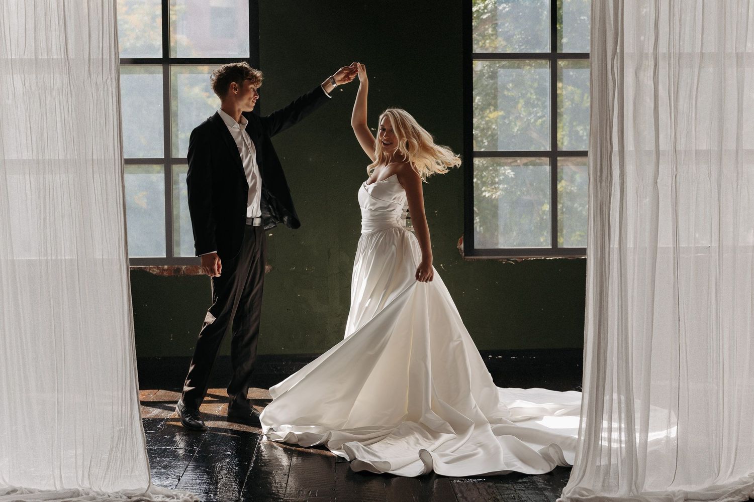 A romantic wedding photo sequence showing a couple dancing together in an elegant venue with large windows.