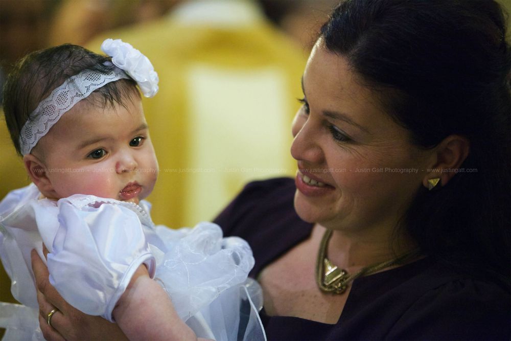 A christening ceremony series showing a baby in white baptismal gown.