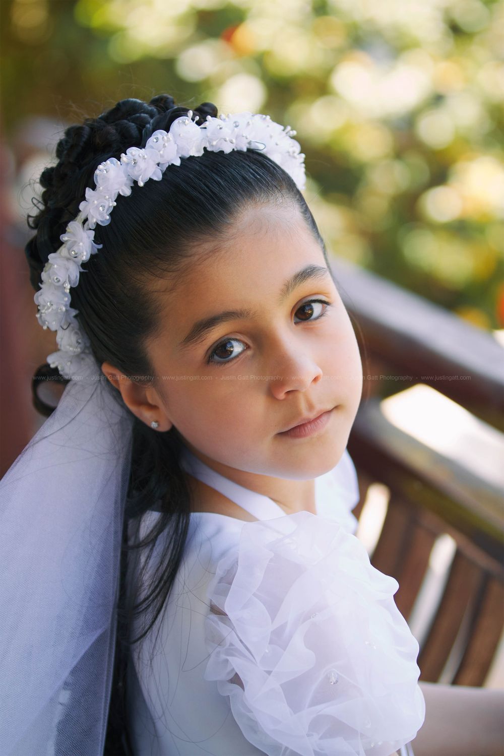 A series showing a child in white first communion dress with floral headpiece and veil.