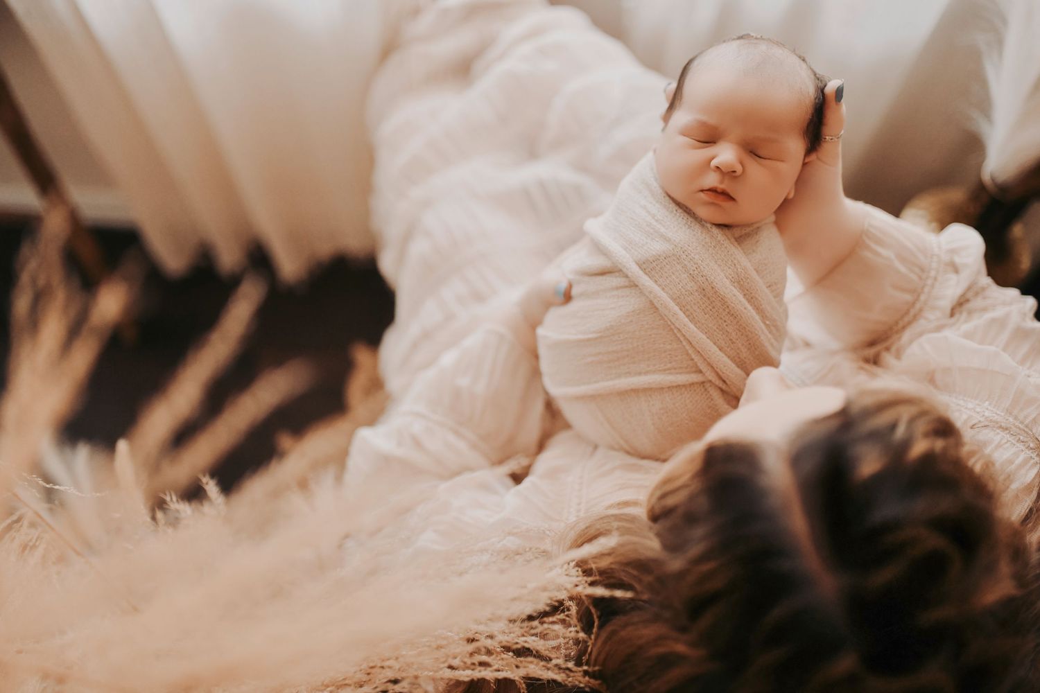 Mother gently rocking her newborn in a calm lifestyle session