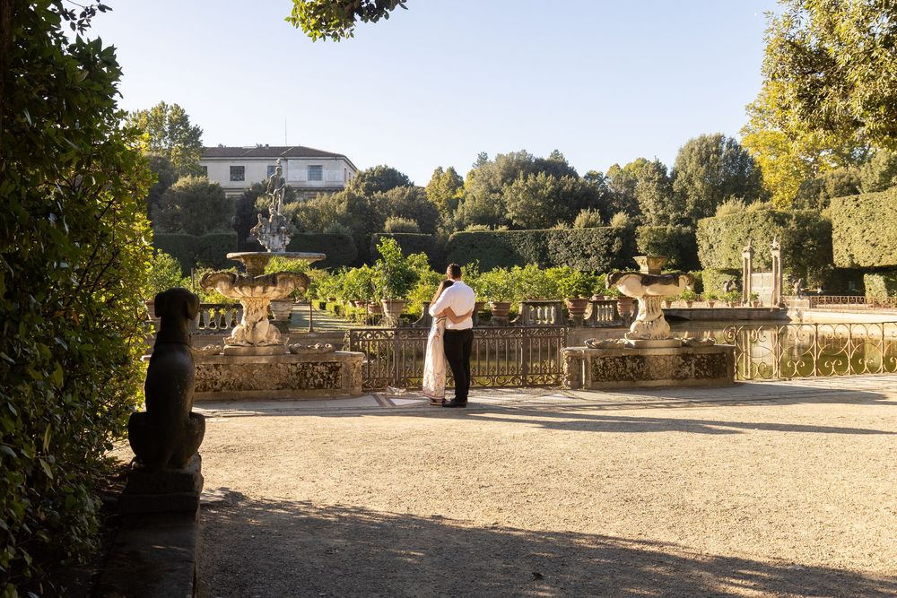 Historic Mission San Juan Capistrano courtyard and garden area surrounded by stone archways and lush vegetation.