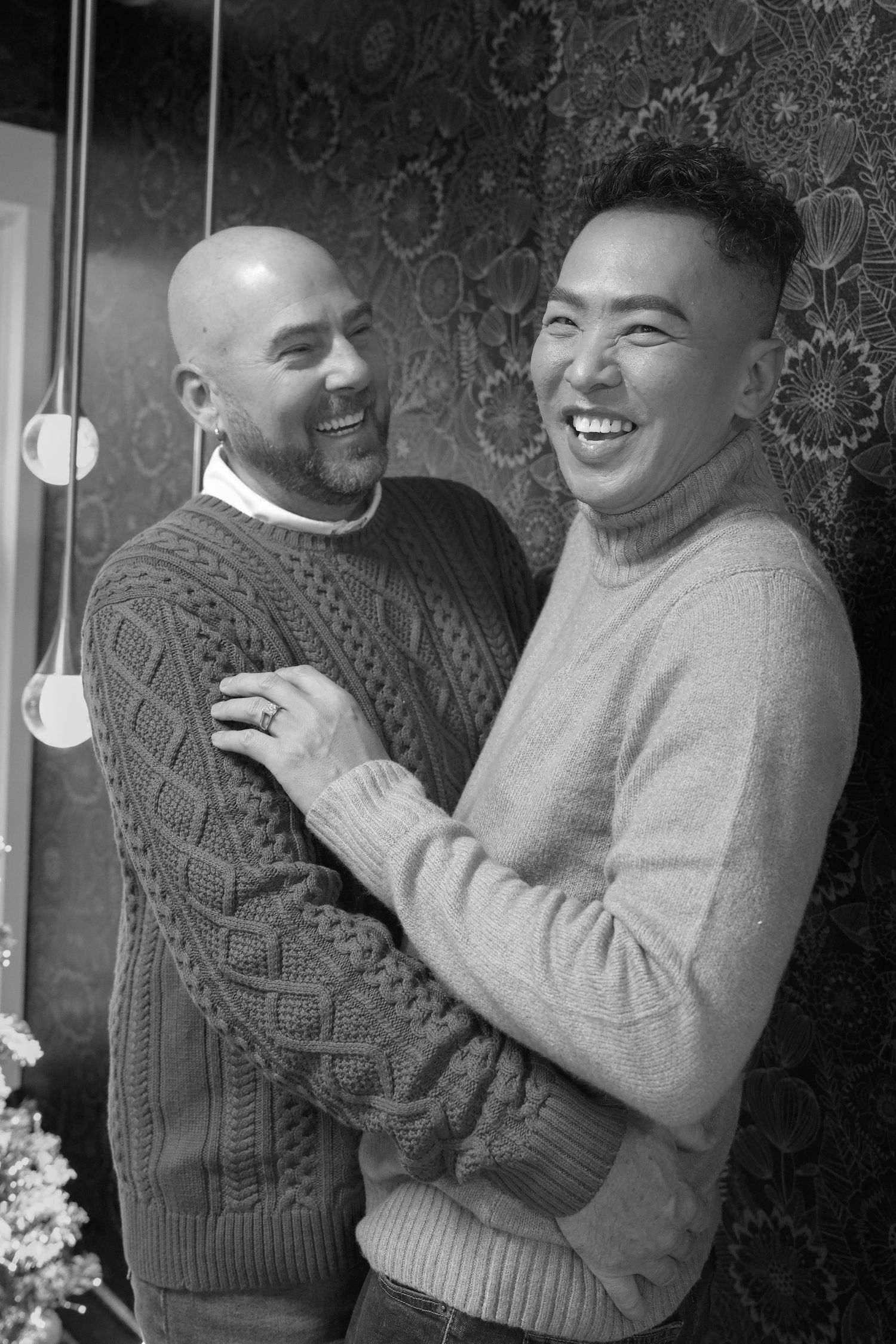 Black and white photo showing three sequential frames of a couple sharing a joyful moment together in matching sweaters.