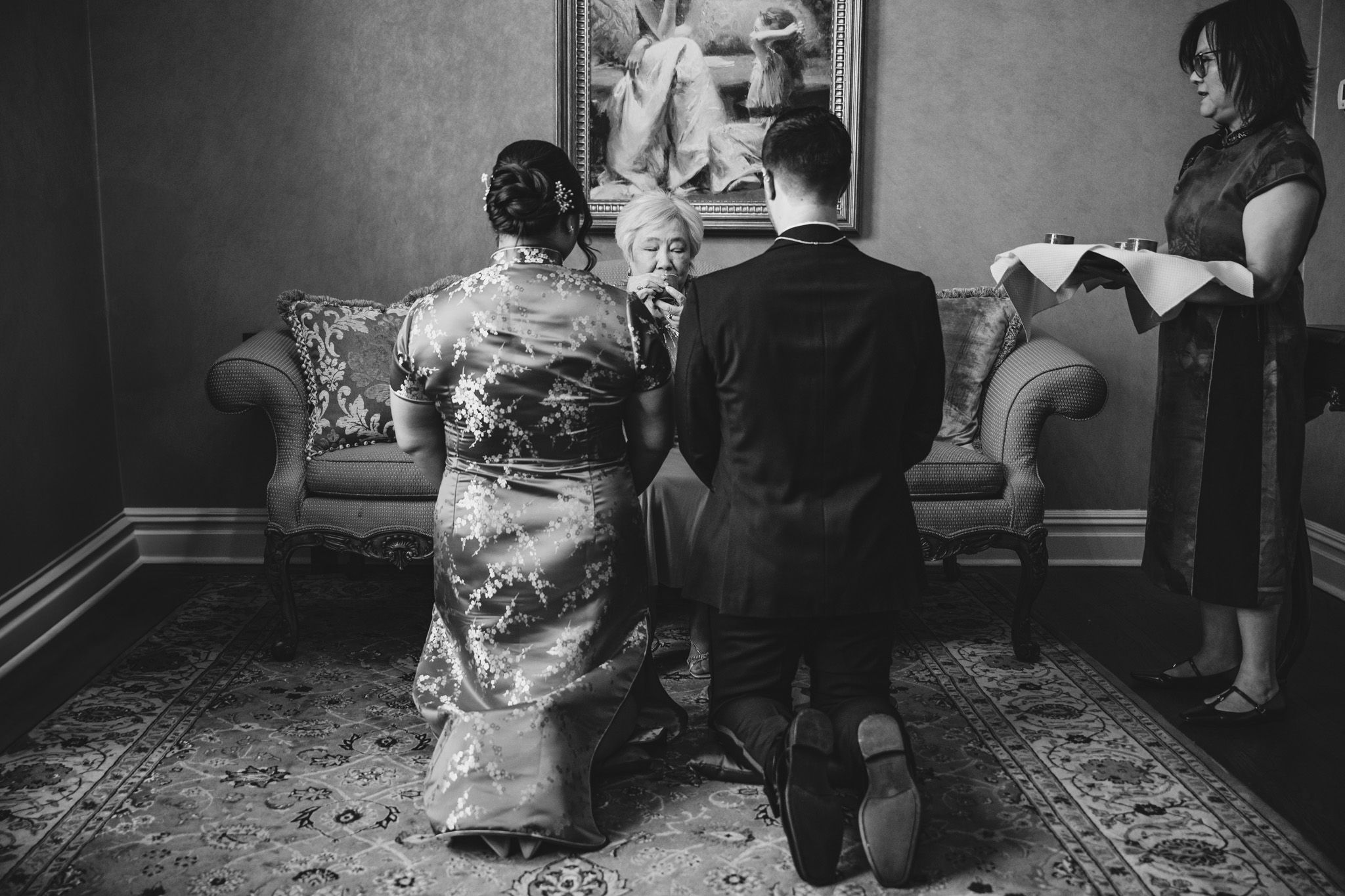 Wedding preparation moments captured in black and white showing intimate details and interactions.