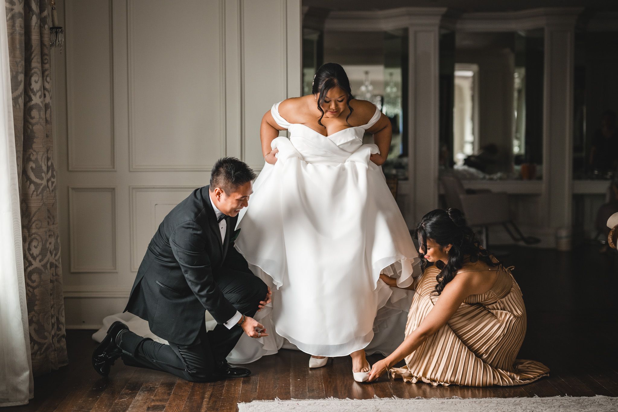 Intimate getting ready moments captured in moody black and white photography.