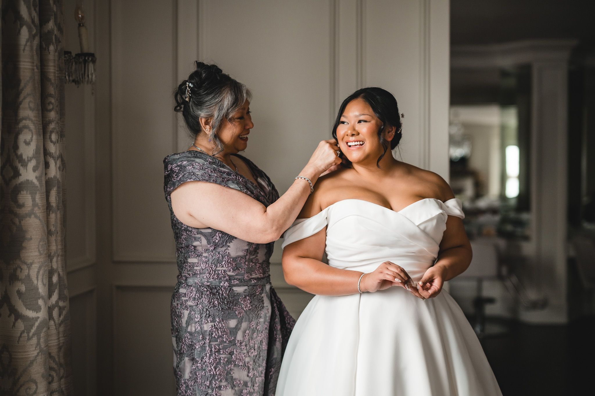 Close-up shots of wedding dress details and final adjustments being made.