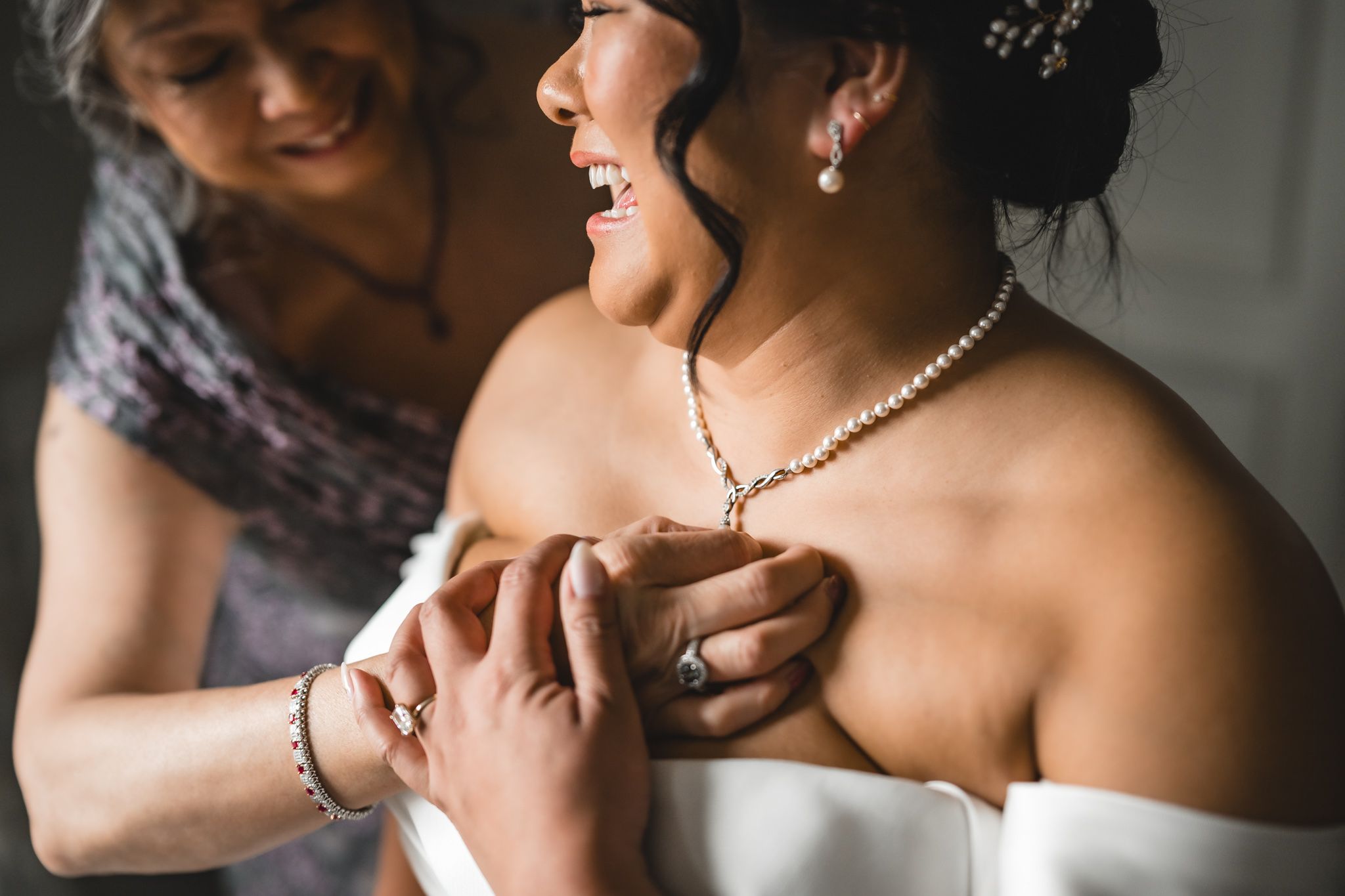 Detailed shots of wedding dress and jewelry preparations in natural window light.