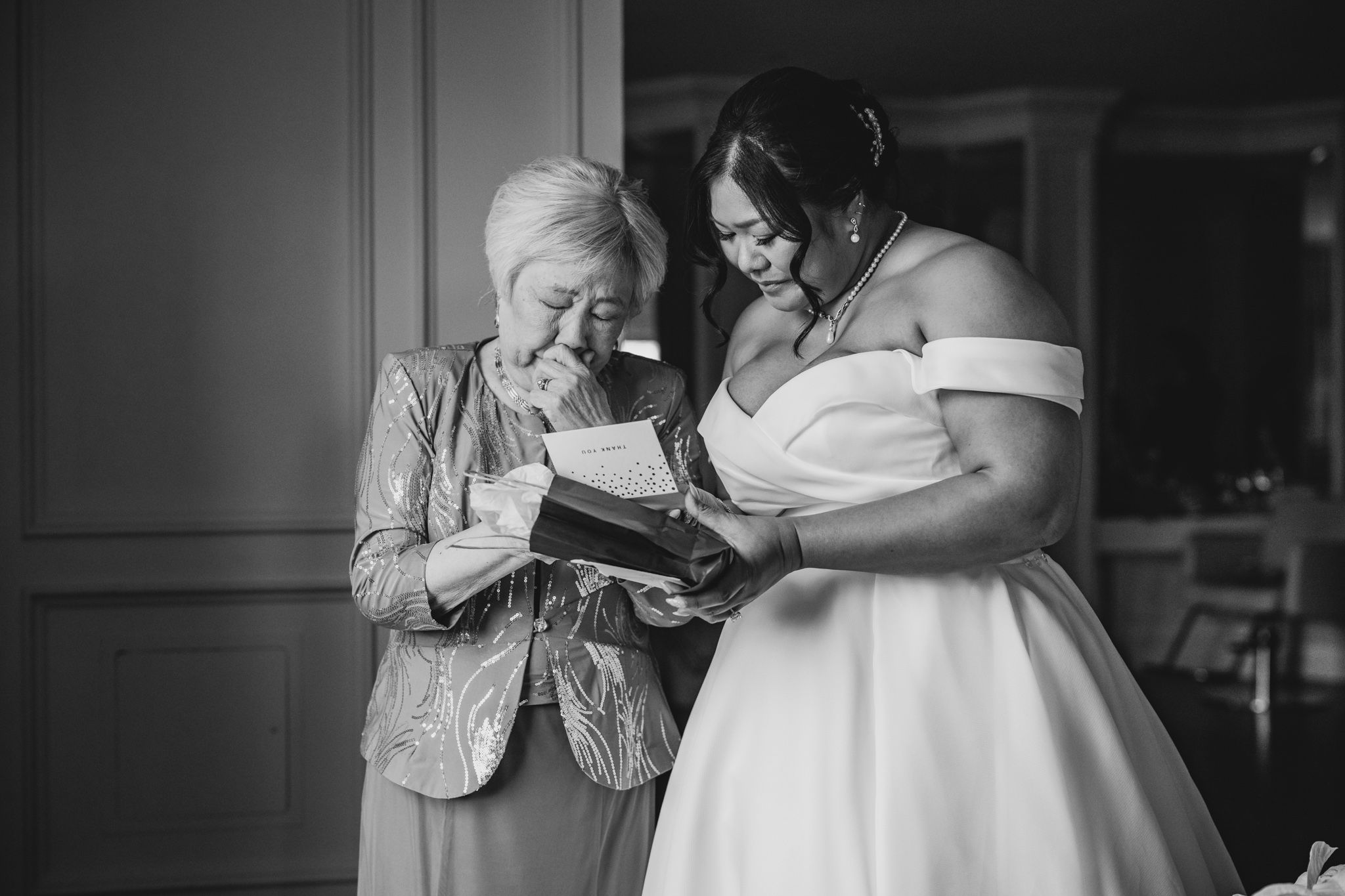 An intimate black and white moment of sharing memories while getting ready for the wedding.