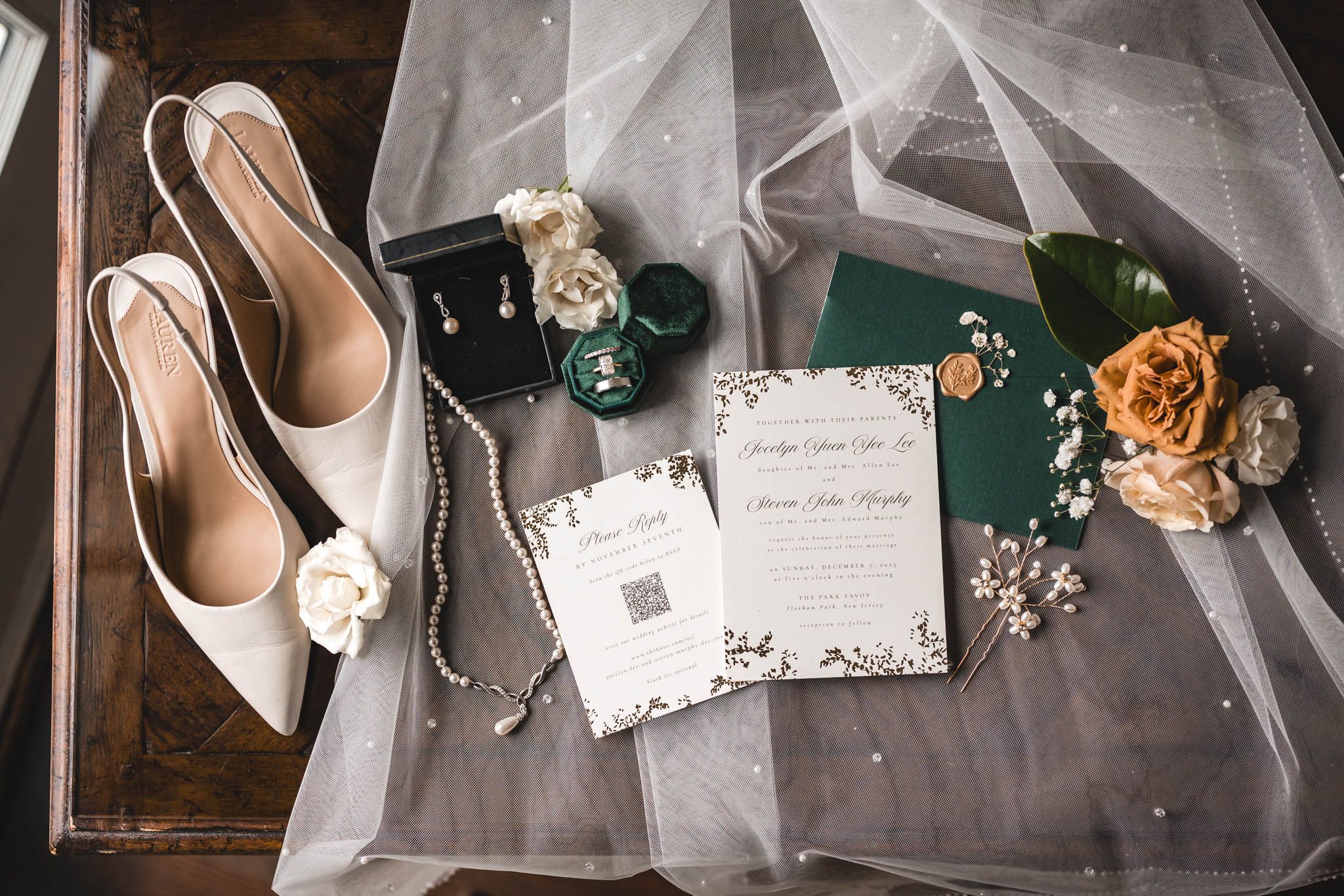 Wedding details including invitations, shoes, and floral elements arranged artistically.