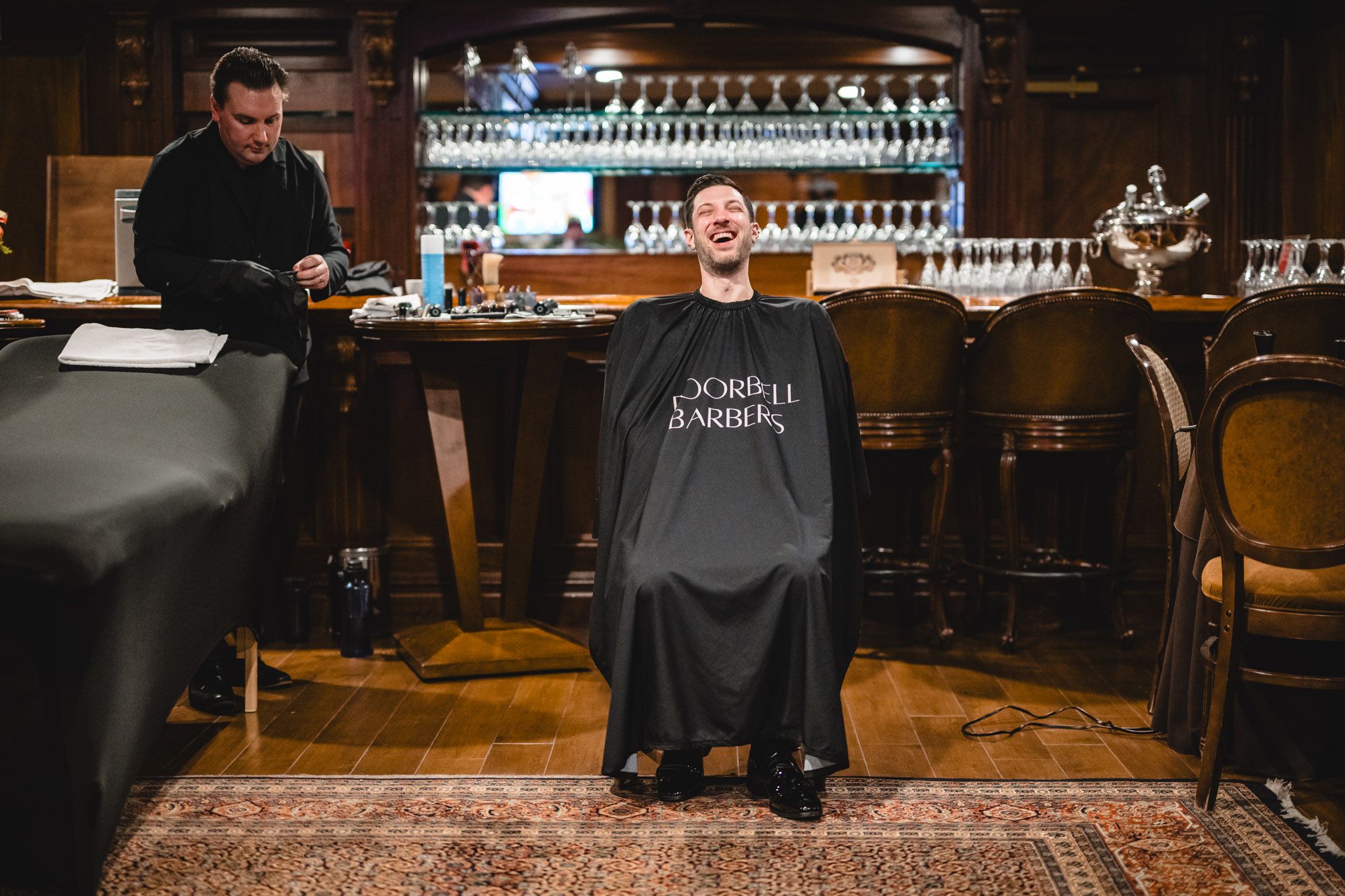 Pre-wedding preparations at a classic wooden bar with vintage decor.