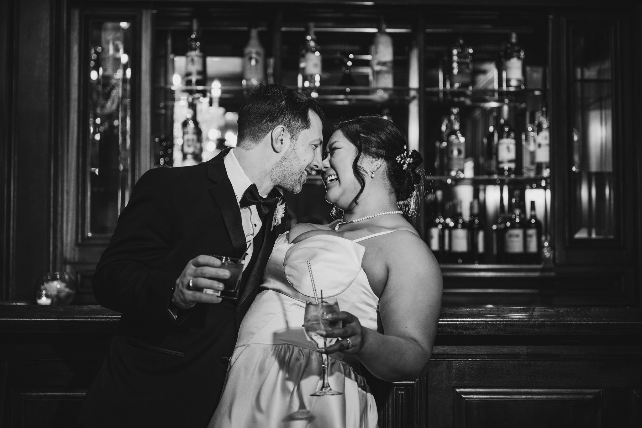 Intimate wedding reception at a dimly lit bar with romantic ambiance.