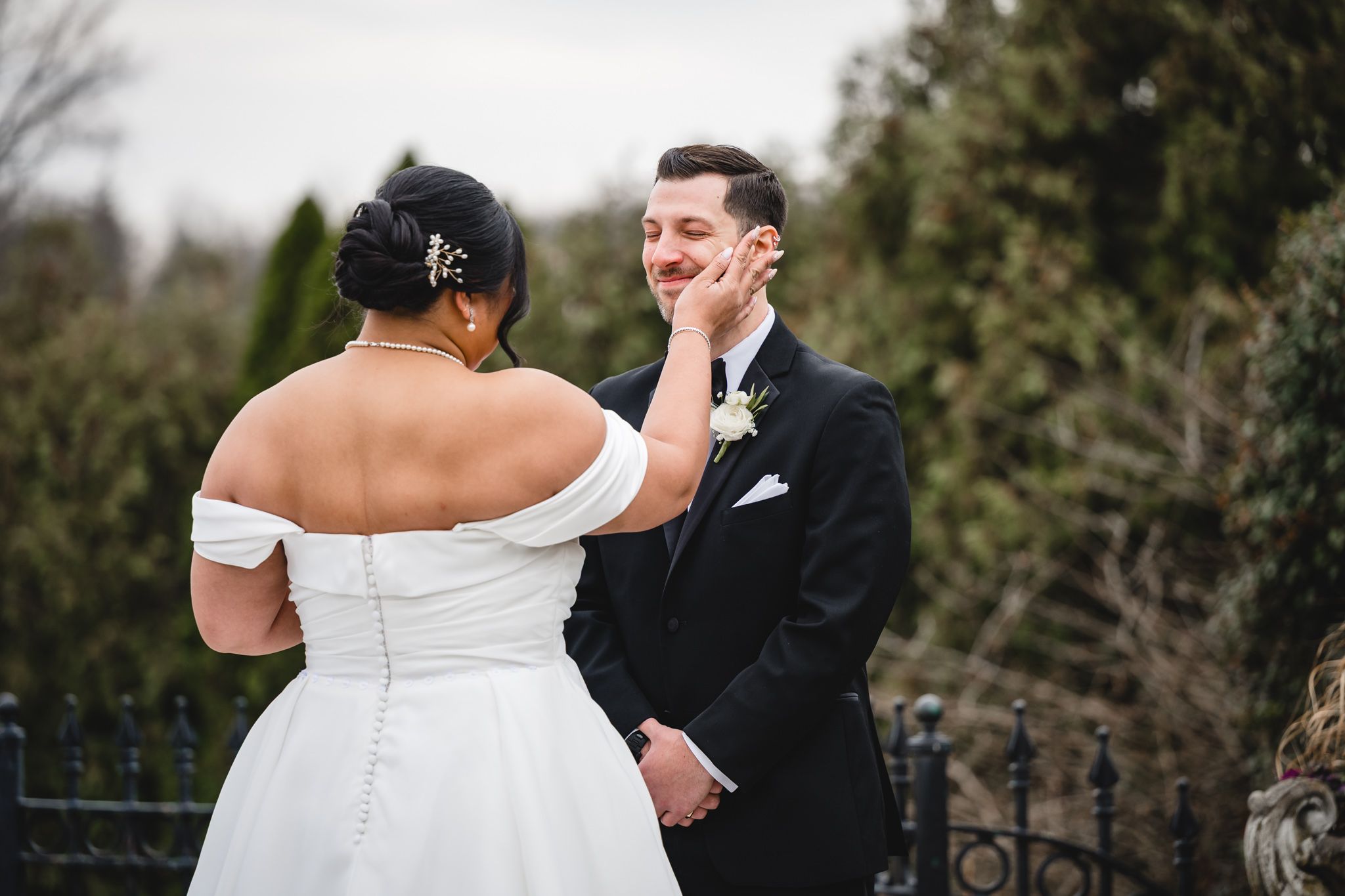 An intimate wedding moment shared between newlyweds during their outdoor ceremony.