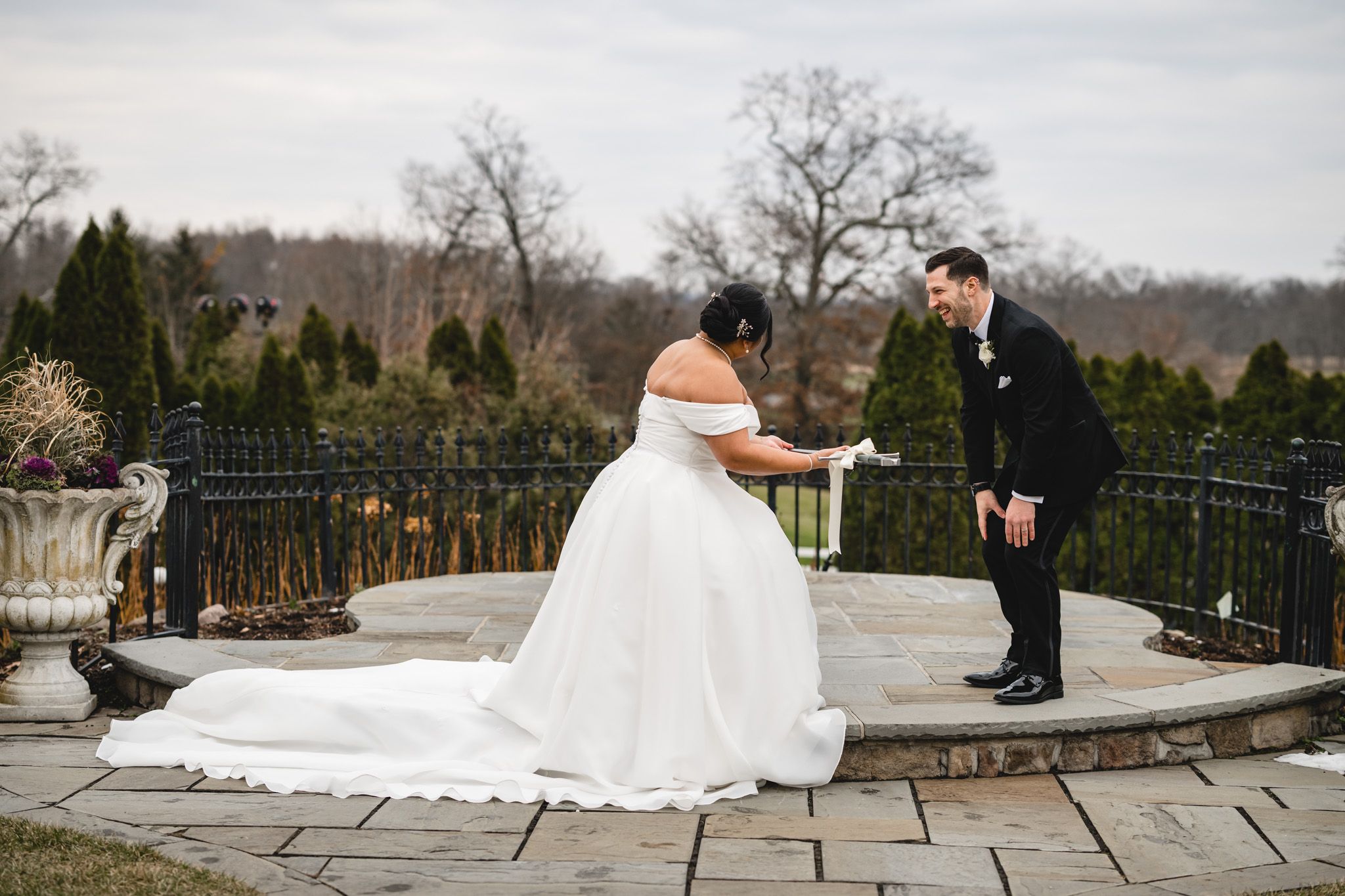 A joyful wedding ceremony moment captured on a circular stone terrace with scenic views.