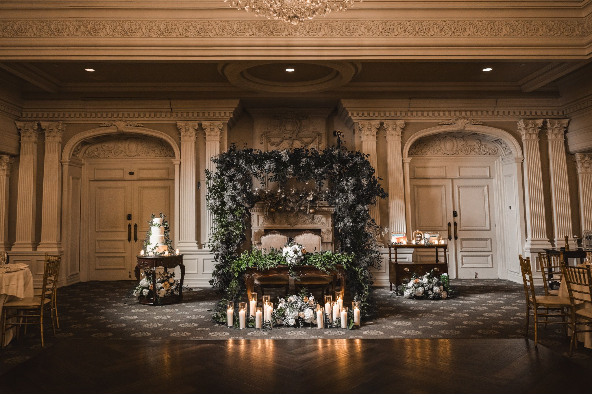 Elegant ballroom with classic architectural details and romantic candlelit decor.