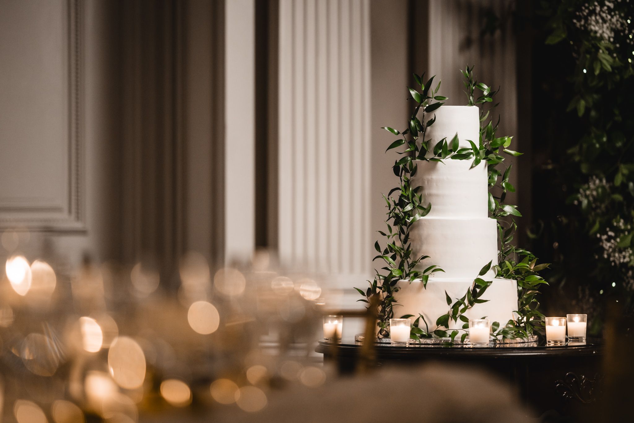 Classic ballroom interior with white columns and soft ambient lighting creating an elegant atmosphere.