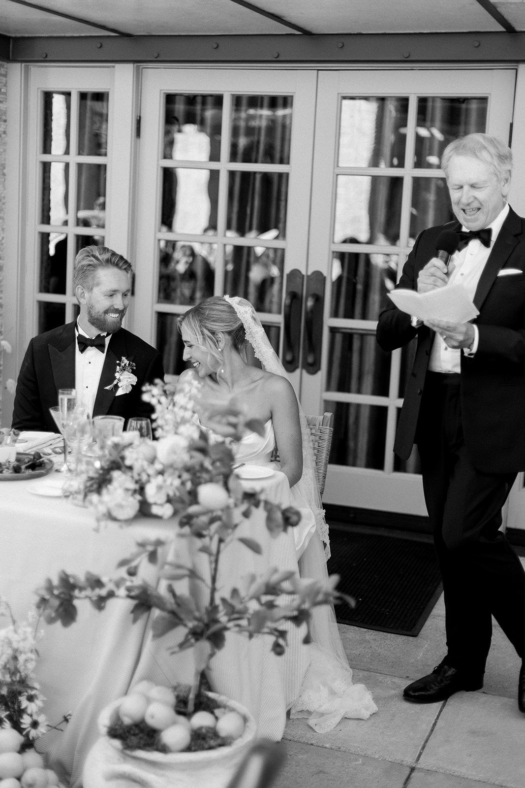 Bride and Groom laughing at speeches during reception at Bernardus lodge