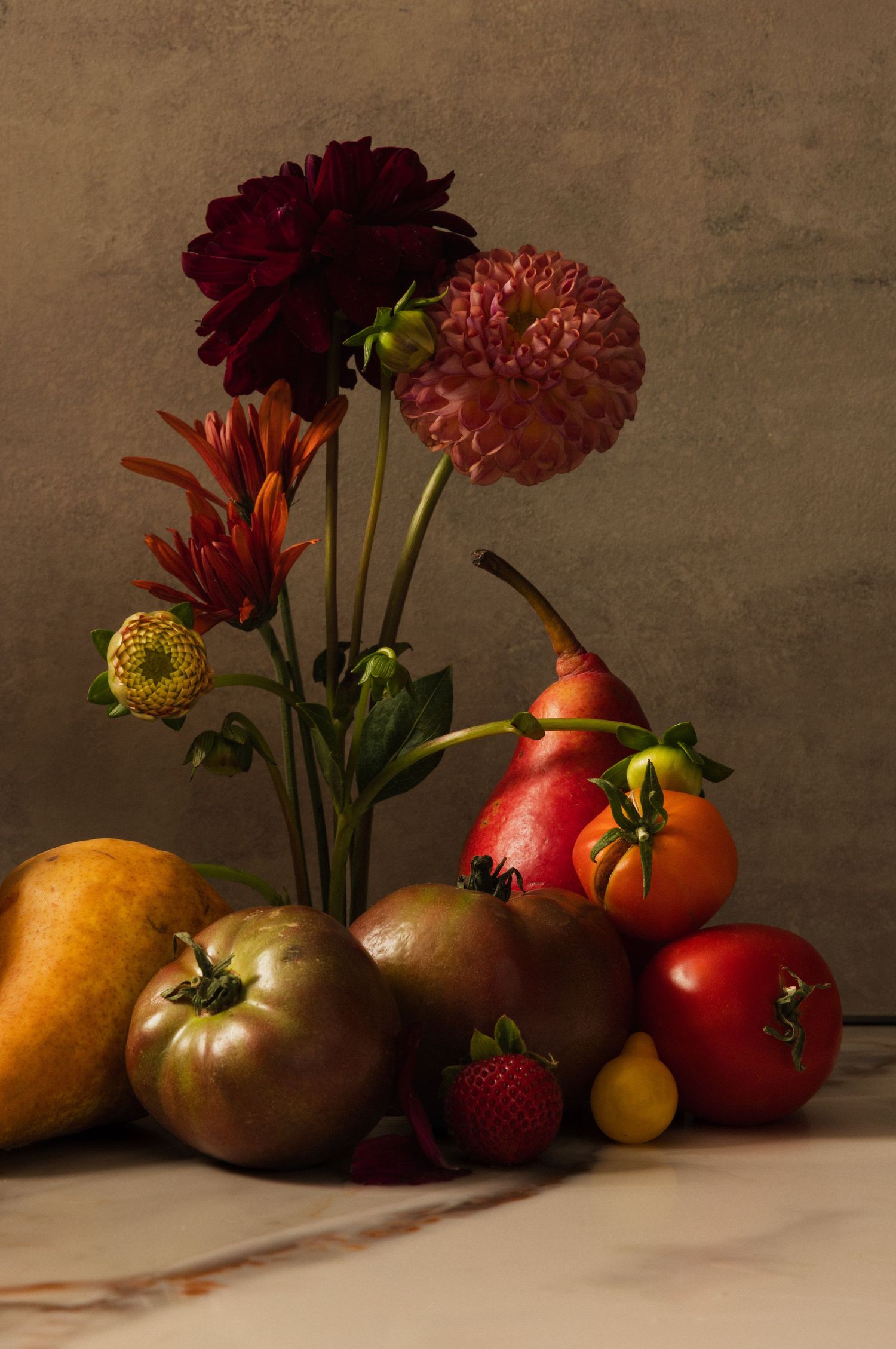 Late Autumn Harvest. Variety of fall produce. Moody still life with vibrant, jewel tone colors, featuring gorgeous florals
