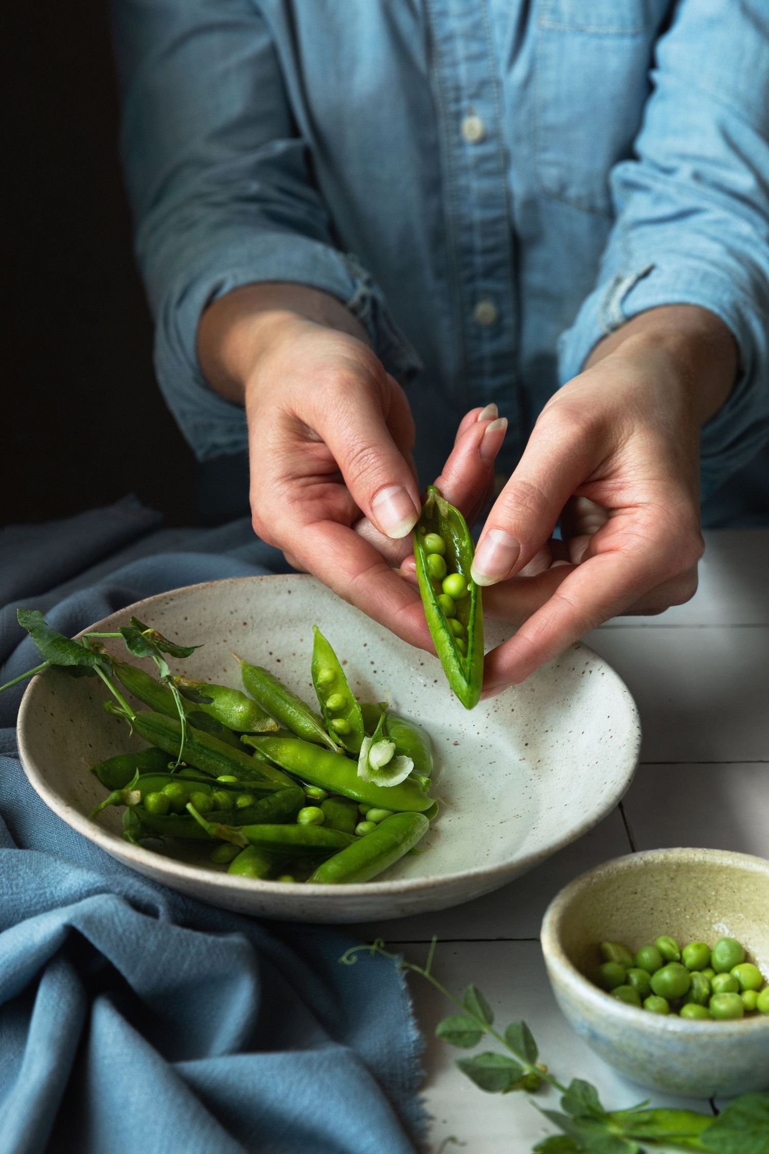 Sugar snap peas styled against a tiled backdrop