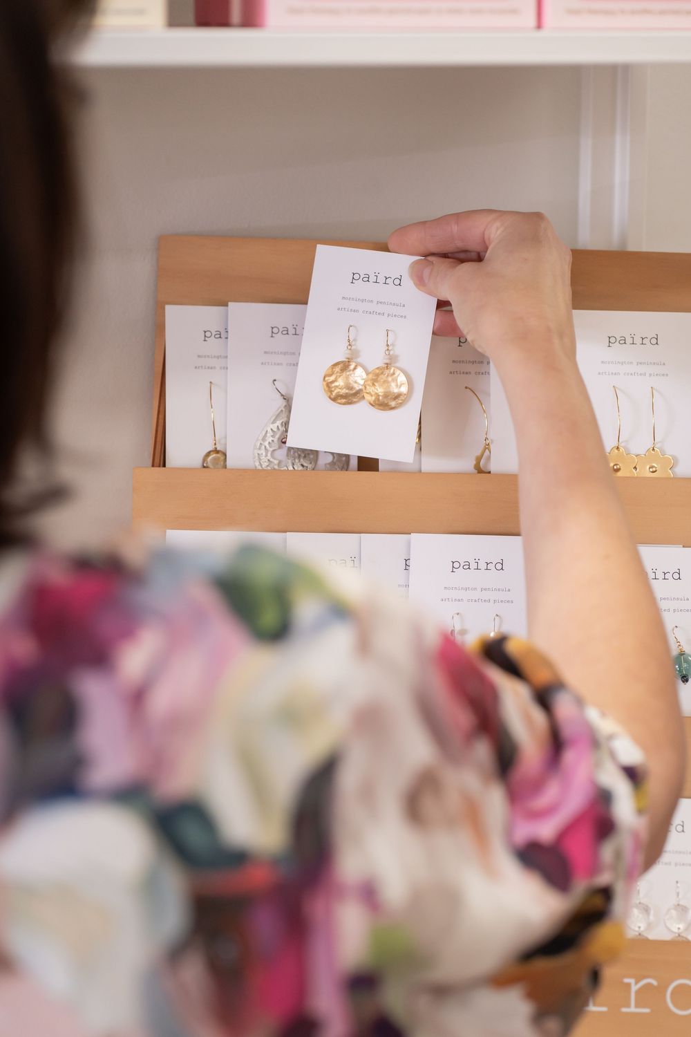 Product cards and jewelry displays arranged on a workspace.