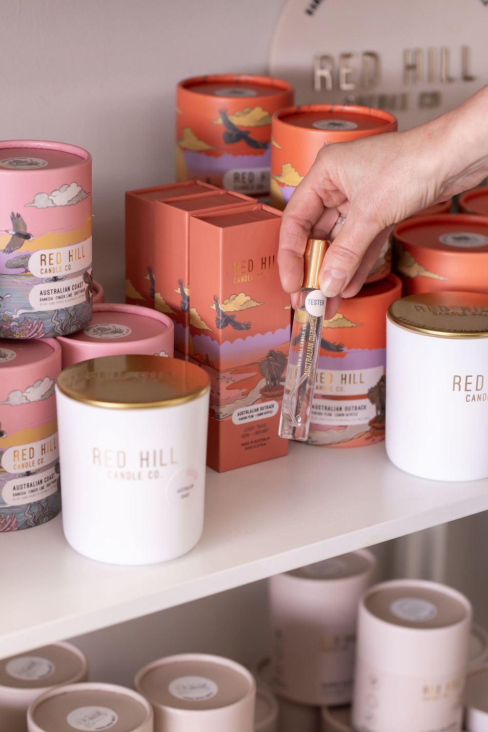 Red Hill branded products neatly arranged on white retail shelving.