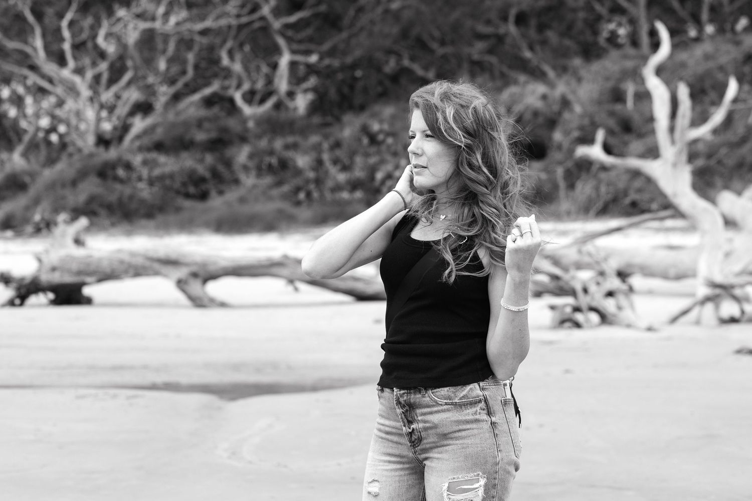 Destination family photographer during a photoshoot on Driftwood Beach in Jekyll Island, Georgia