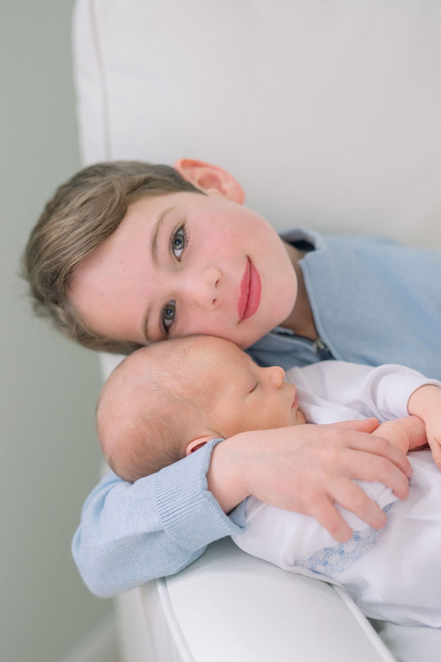 Sibling holding new baby during a lifestyle newborn session in Arlington Virginia