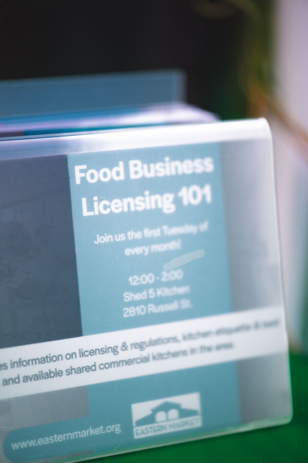 A series of blurred business signs or text displays showing licensing and business information against a dark background.