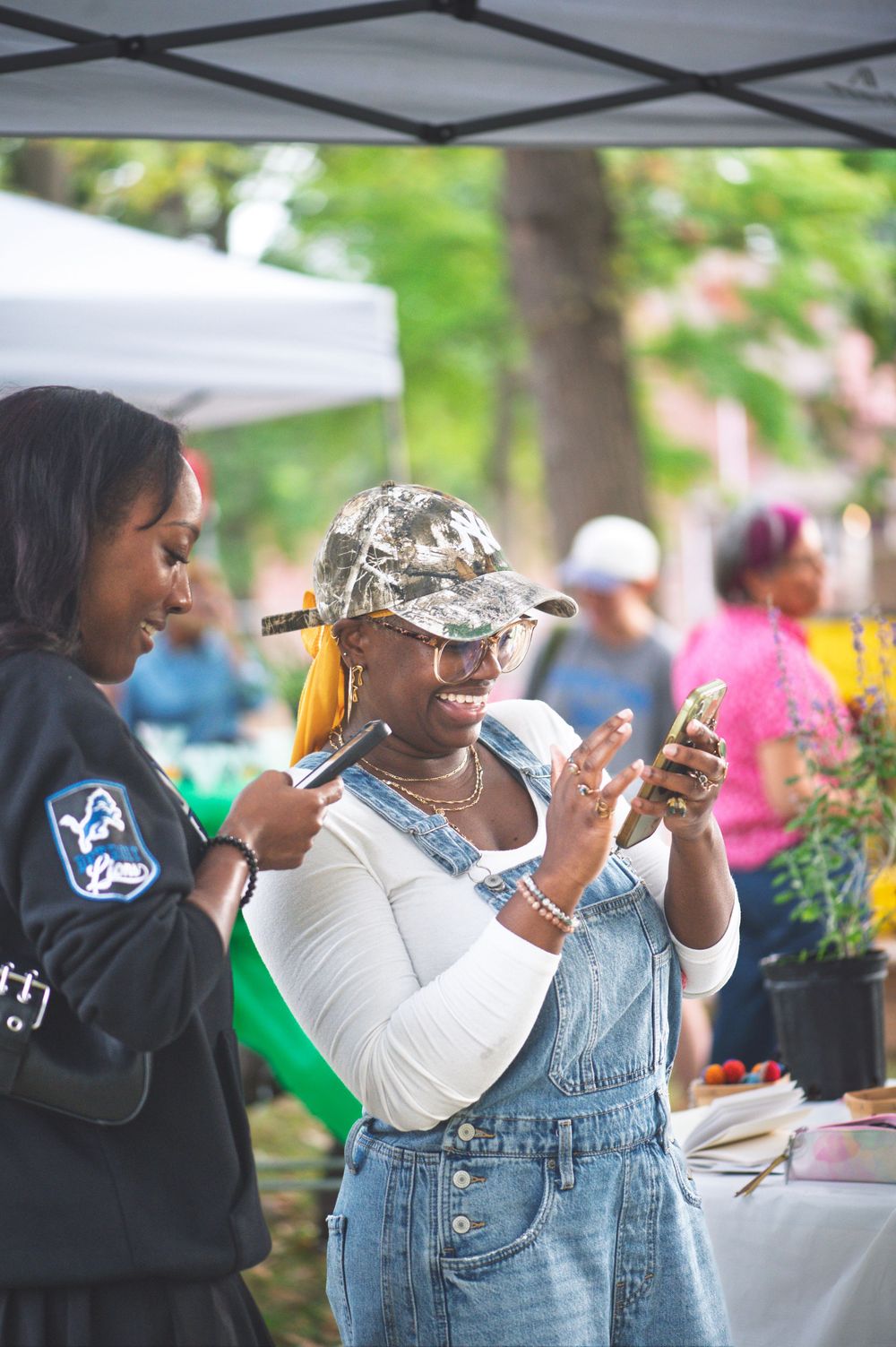 People enjoying food and drinks at an outdoor community gathering or festival on a sunny day.