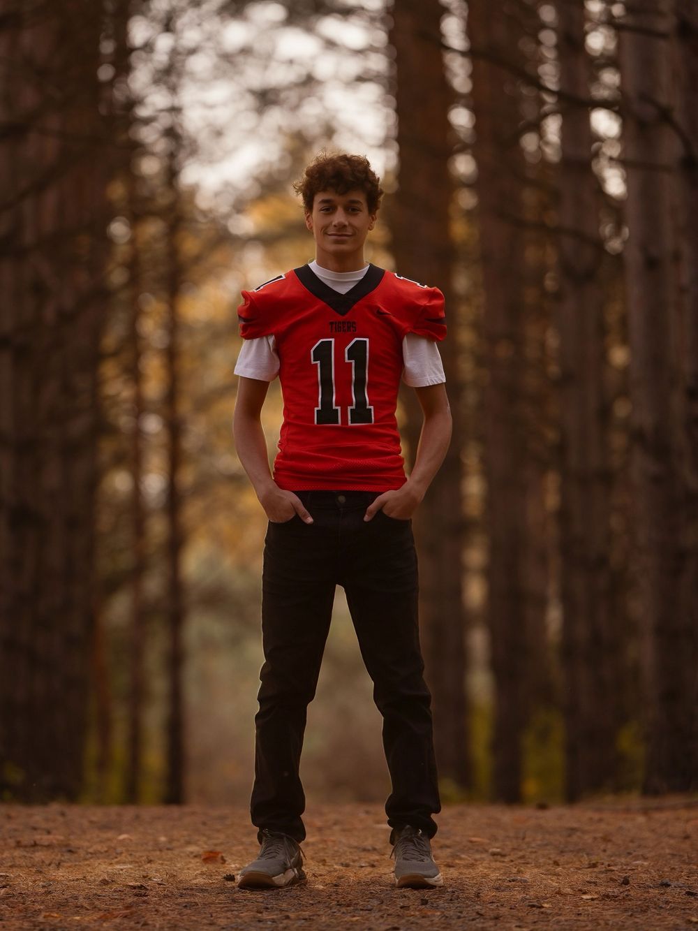 A sequence of outdoor photos showing someone in a red sports jersey number 11 among pine trees.