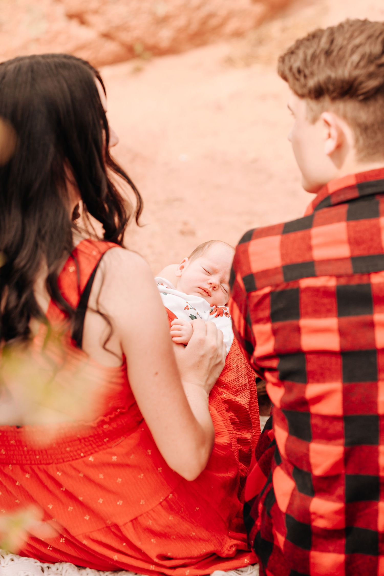 parents looking at their newborn baby